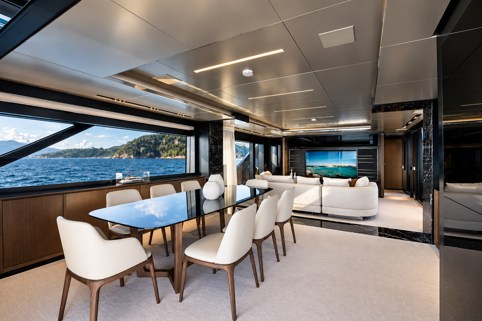 Luxury yacht main salon with concealed motorized display and panoramic ocean view