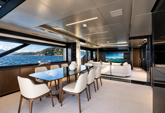 Luxury yacht main salon with concealed motorized display and panoramic ocean view